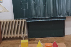 Geometrická tělesa na tabuli.