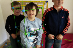 Žáci staví komín ze speciální stavebnice.