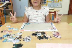 Dívka staví puzzle.